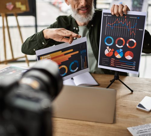 A professional shares insights with charts in a sleek office during a business meeting.